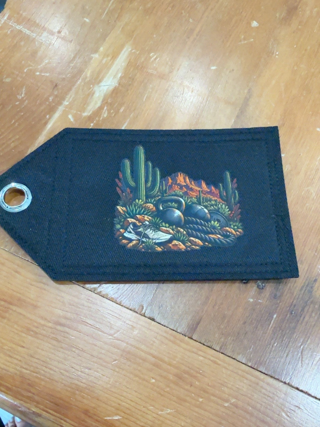 Phoenix brown desert Patch Tag featuring cacti, kettlebells, battle rope, running shoe and red rock landscape